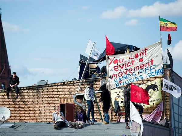 Flüchtlinge und Unterstützer harren auf dem Dach aus. Doch wie lange noch? Die Polizei hat mittlerweile den Auftrag die Schule zu räumen.