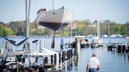 Abgehoben: Ein Segelboot wird im Hafen des Vereins Seglerhaus am Wannsee mit einem Kran ins Wasser gelassen.