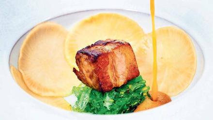 Köstlich! Der „Signature Dish“ – gerösteter Schweinebauch mit Algen, Litschi und eingelegtem Rettich – ist so etwas wie das Markenzeichen des frisch besternten „Kochzimmer“ in Beelitz, eine ausgefeilte Kombination.