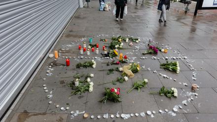 Blumen und Kerzen liegen in Hamburg in einem Peace-Zeichen auf dem Bürgersteig vor dem Supermarkt, in dem am 28.07.2017 ein Mann einen Menschen mit einem Messer getötet und sechs weitere verletzt hat.