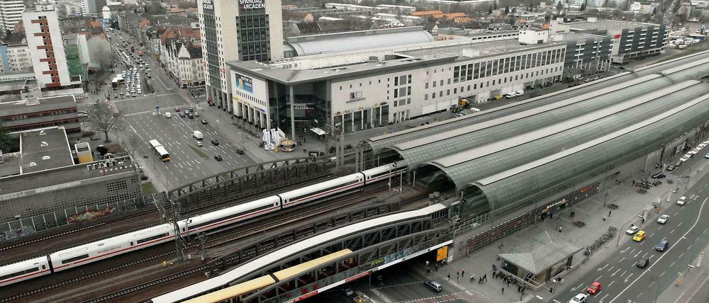 Willkommen im Jetzt. Das ist der Bahnhof Spandau: Vier Fernbahngleise (plus ein Gütergleis ganz hinten), dazu zwei S-Bahngleise. Das Foto entstand vom Rathausturm. In der Lücke zwischen Bahnhof und Einkaufszentrum (Bj 2001) sollte übrigens mal der Transrapid haltenn. 