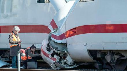Bahntechniker begutachten den Schaden an den Zügen.