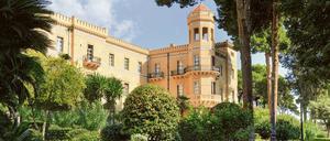 Ein Spaziergang durch den Garten: In der Villa Igiea können Besucher unter Palmen und blauem Himmel abschalten.