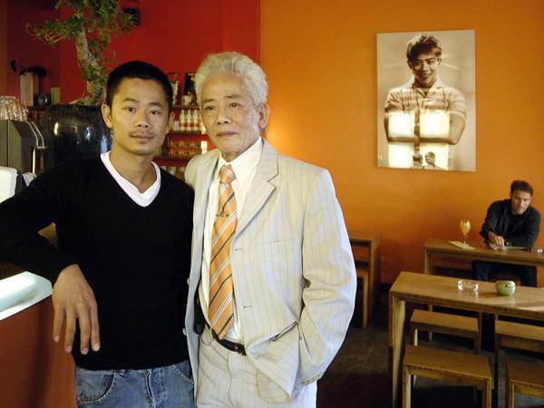 Dat Vuong mit seinem Vater 2005 im Lokal in der Alten Schönhauser Straße. Hinten an der Wand das Selbstporträt des Familienoberhaupts aus den 1970ern.