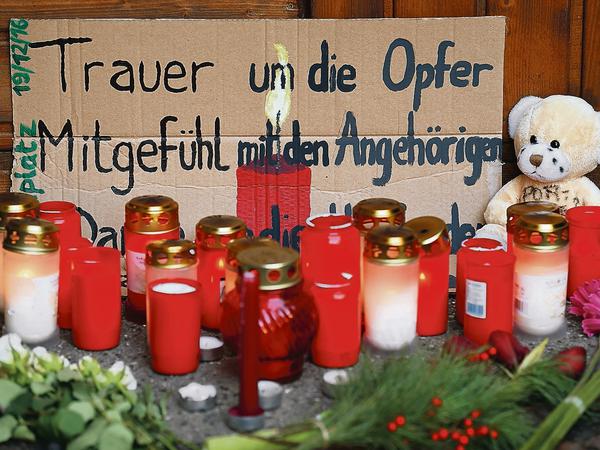 Beileidsbekundungen und Schilder liegen zwischen Blumen und Kerzen in Berlin unweit der Stelle des Anschlags auf dem Weihnachtsmarkt am Breitscheidplatz. 