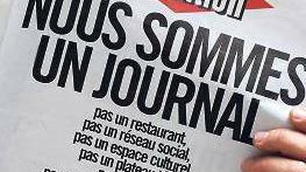„Wir sind eine Zeitung“, mit dieser Schlagzeile protestiert die Redaktion der „Libération“ gegen die Umbaupläne. Foto: AFP