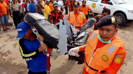 Indonesische Sicherheitskräfte mit einem Sitz aus der abgestürzten AirAsia-Maschine. 