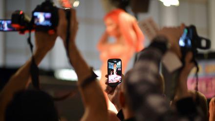 Besucher filmen und fotografieren während der Erotik-Messe «Venus» in Berlin die Vorführungen einer Frau. 