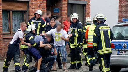 Drei Männer behindern am 05.07.2015 in Bremervörde (Niedersachsen) nach einem tödlichen Unfall die Arbeit der Rettungskräfte.