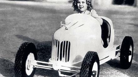 Shirley Temple in einem Kinderrennwagen in den 30er Jahren. 