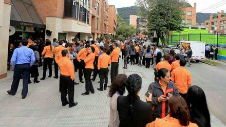 Menschen in Bogotá warten vor einem Gebäude. Ein Erdbeben hat Kolumbien erschüttert. 