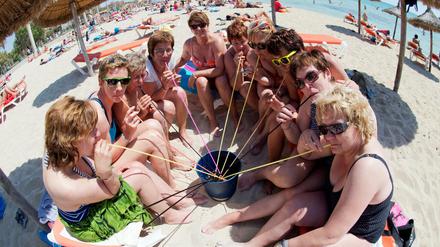 Eine Frauengruppe aus Neumünster trinkt aus einem Eimer am Strand von Arenal auf der Mittelmeerinsel Mallorca (Spanien). "Saufgelage" sind hier bald wieder verboten. 