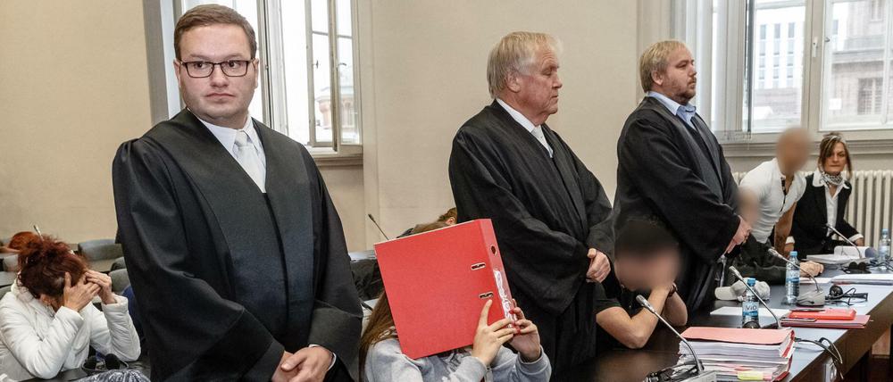 Die Angeklagten sitzen in Hamburg zwischen ihren Verteidigern auf der Anklagebank.