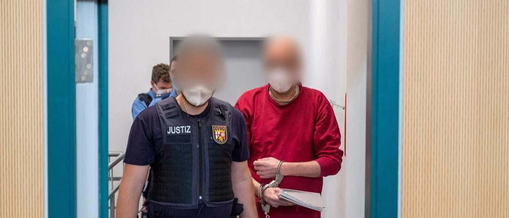 in Justizbediensteter begleitet den 52-jährigen Angeklagten zum Prozess um die tödliche Amokfahrt in Trier in den Gerichtssaal.