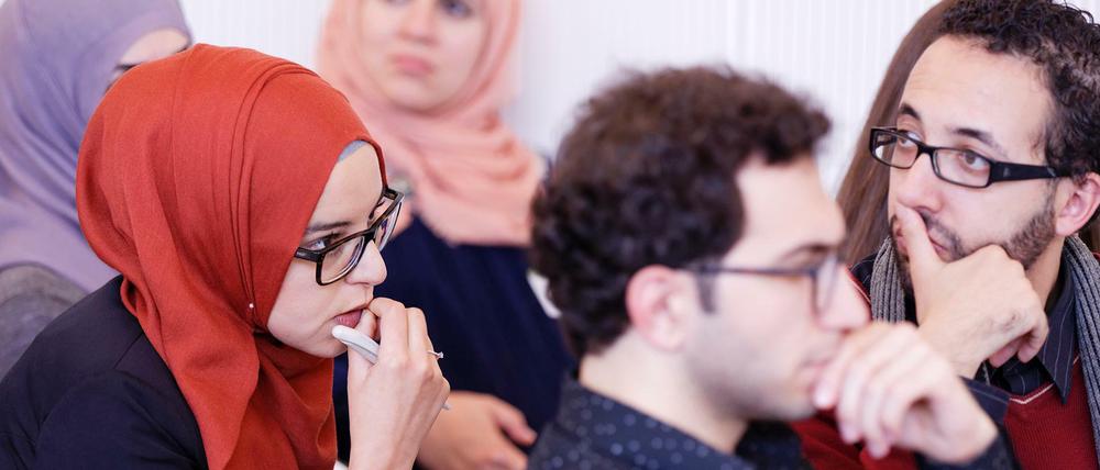 Teilnehmer des Graduiertenkollegs Islamische Theologie sitzen bei einer Veranstaltung im Publikum.