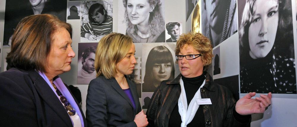 Die Bundesministerinnen Sabine Leutheusser-Schnarrenberger (l./FDP) und Kristina Schröder (M./CDU) unterhalten sich im früheren geschlossenen Jugendwerkhof in Torgau mit der Betroffenen Heidemarie Puls, die im Porträtraum auf ihr Foto zeigt.