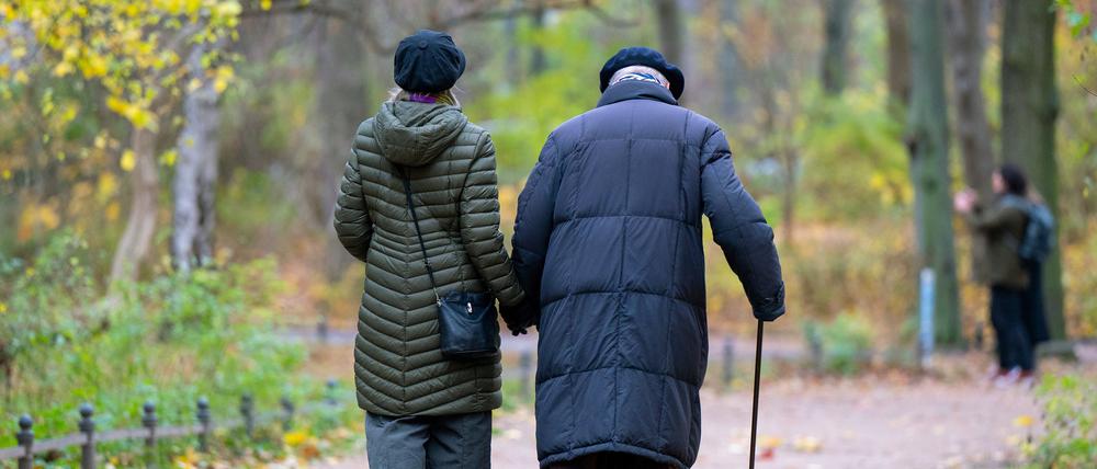 Ein älterer Mann mit einem Gehstock und seine Begleitung spazieren: Die rund 21 Millionen Rentnerinnen und Rentner in Deutschland können ab Juli 2024 mit einer Erhöhung ihrer Rente um 3,5 Prozent rechnen. (Archivfoto)
