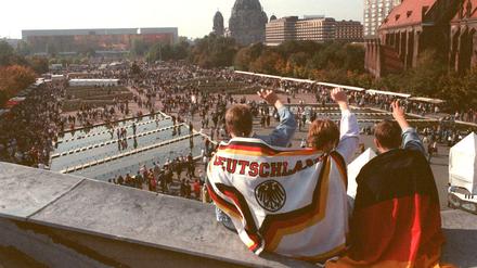 Auf dem Platz hinter dem Fernsehturm feiern die Menschen am 03.10.1990 den Tag der deutschen Einheit. 