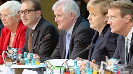Die Union um Kanzlerin Merkel will die Arbeitswelt nach ihren Wünschen formen.