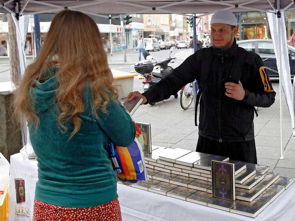 Ein Salafist verteilt ein kostenloses Koranexemplar in der Fußgängerzone von Offenbach am Main.