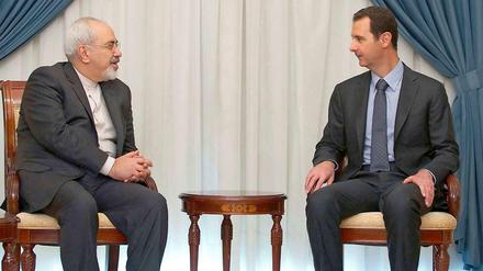 Verbündete: Irans Außenminister Sarif und Syriens Herrscher Assad.