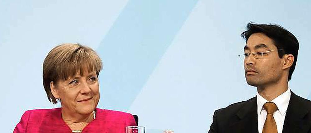 FDP-Chef Rösler (r.) will Druck machen, aber noch bleibt Bundeskanzlerin Angela Merkel offenbar gelassen.