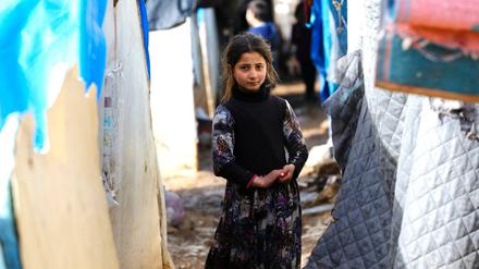 Ein syrisches Mädchen steht zwischen provisorischen Zelten, die auf dem Weg in die Türkei errichtet wurden. 