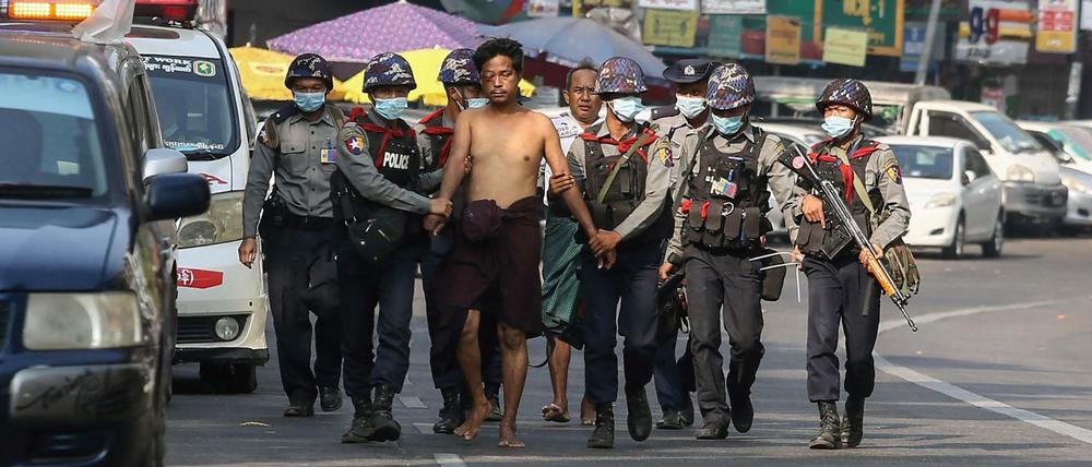 Polizisten in Yangon führen einen Festgenommenen ab (Archivbild vom 26. Februar 2021) 