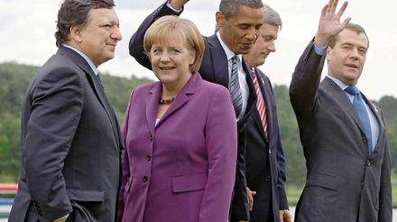 Angela Merkel mit dem russischen Präsidenten Medwedew (li.) und dem britischen Premier David Cameron. 