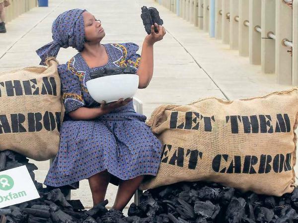 Lass sie doch Kohle essen! Am Strand von Durban protestiert am Freitag einsam, aber einfallsreich Oxfam-Mitglied Busi Ndlovu gegen die Nutzung von Kohle.