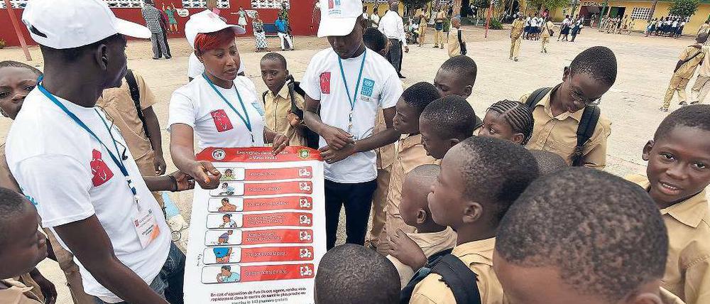 Mitarbeiter der Vereinten Nationen vermitteln Schülern in der Elfenbeinküste, wie sie sich am besten vor Ebola schützen können.