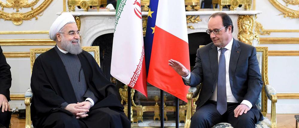 Das Säckel voll Geld - Irans Präsident Ruhani und Frankreichs Präsident Hollande