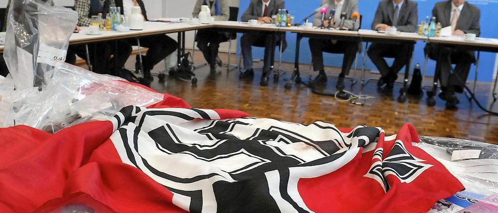 Eine Hakenkreuzfahne, Waffen und Propagandamaterial sind beschlagnahmt worden und liegen am Dienstag bei einer Pressekonferenz. Die bedeutendste Neonazi-Gruppe Niedersachsens "Besseres Hannover" hat das Land jetzt verboten.