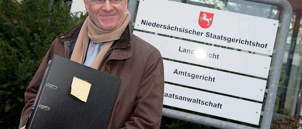 Der ehemalige niedersächsische Innenminister und SPD-Abgeordnete Heiner Bartling mit der Akte, die die Klage enthält.