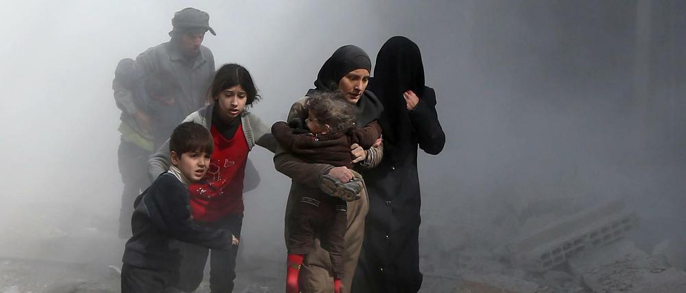 Auf der Flucht vor den Bomben. Menschen im von Regime-Truppen abgeriegelten Ost-Ghouta bringen sich vor Luftangriffen in Sicherheit.