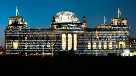 Aktivisten der Umweltorganisation Greenpeace projizieren am frühen Morgen des 02.05.2016 Teile des bisher geheimen Verhandlungstextes und den Schriftzug "Demokratie braucht Transparenz" auf die Fassade des Reichstagsgebäudes in Berlin, den Sitz des Deutschen Bundestages. 