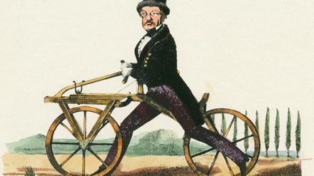 Der Erfinder Karl Drais (1785-1851) auf seiner Laufmaschine.