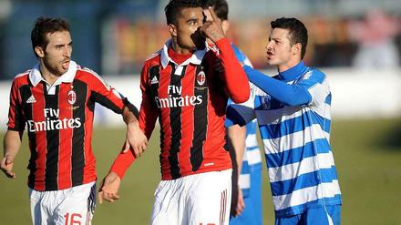 Milans Mittelfeldspieler Kevin-Prince Boateng (M.) zeigt den Fans den Vogel beim Testspiel gegen Pro Patria.