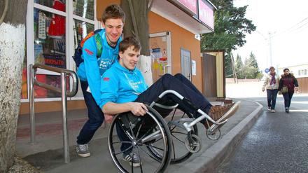 Jonas Wengert (im Rollstuhl) und George Simonds, Schülerreporter der Paralympics Zeitung / Paralimpijskij testen die Barrierefreiheit von Bahn, Bus und Strassen im Stadtgebiet.