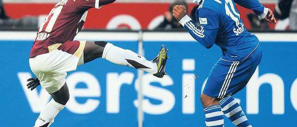 Vergebliches Strecken. Auch dieses Handspiel half Hannovers Didier Ya Konan (l.) nicht gegen Jefferson Farfans Schalker. Foto: AFP