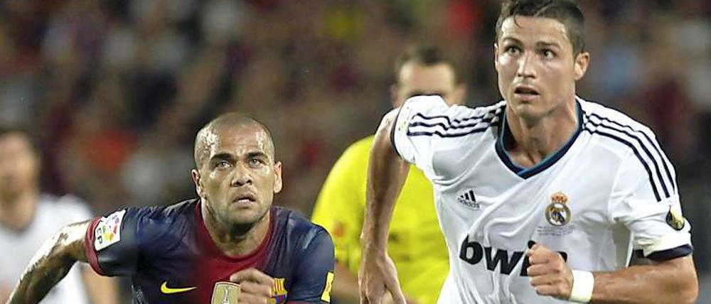 Zwei in einer Elf. Im Alltag sind Dani Alves (links) und Cristiano Ronaldo Gegner. Am Montag standen Barcelonas brasilianischer Verteidger und Reals portugiesischer Stürmer virtuell in einer gemeinsamen Mannschaft. 