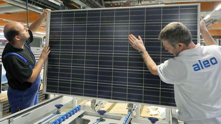 Alles palett? Zwei Mitarbeiter der aleo solar AG in Prenzlau kontrollieren hier ein Solarmodul nach der Fertigstellung. Diese Qualitätskontrolle war offenbar nicht immer ausreichend. 