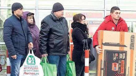 Schlange stehen. Weil die Russen um den Wert des Rubels fürchten, plündern viele ihre Konten, um einkaufen zu gehen. 