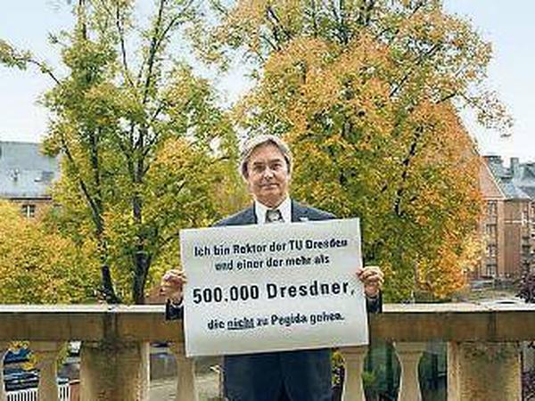 Ein Mann hält ein Schild mit der Aufschrift "... einer der mehr als 500000 Dresdner, die nicht zu Pegida gehen".
