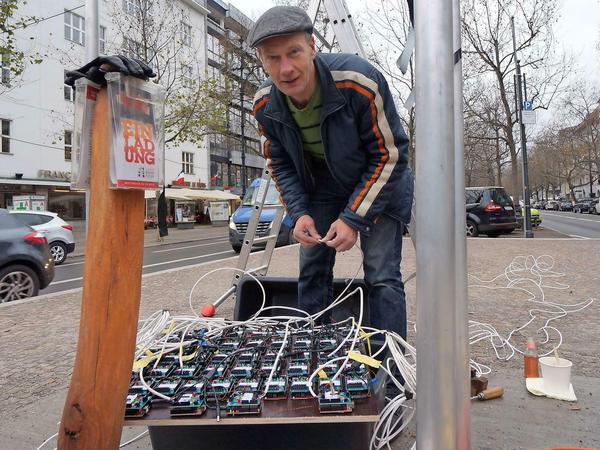 Künstler Nils-R. Schultze verdrahtet die Schaltkreise kurz vor der Inbetriebnahme auf dem Kurfürstendamm.