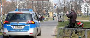Police patrol Volkspark Friedrichshain, but people enjoy the great weather and keep their distance.
