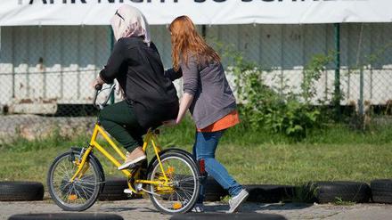 Die Frauen konnten oder durften das Fahrradfahren in ihren Herkunftsländern nicht erlernen. Mit Hilfe von ehrenamtlichen Helfern lernen sie es nun auf einem Verkehrsübungsplatz in Dresden.