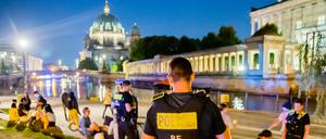 Polizisten patrouillieren im James-Simon-Park im Berliner Bezirk Mitte und weisen Besucher auf das Alkoholverbot hin.
