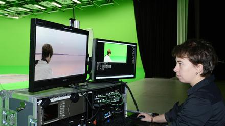 Eine Mitarbeiterin bearbeitet im Aufnahmestudio auf dem Gelände der Filmstudios in Potsdam Babelsberg einen virtuellen Hintergrund.