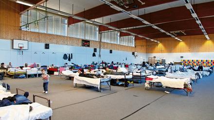 Flüchtlinge in einer Sporthalle.